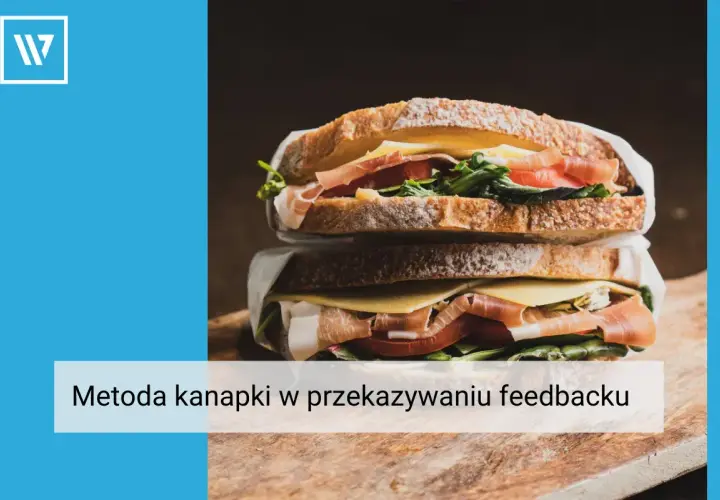 Apetyczna kanapka z szynką, serem i warzywami, symbolizująca metodę kanapki w przekazywaniu feedbacku.