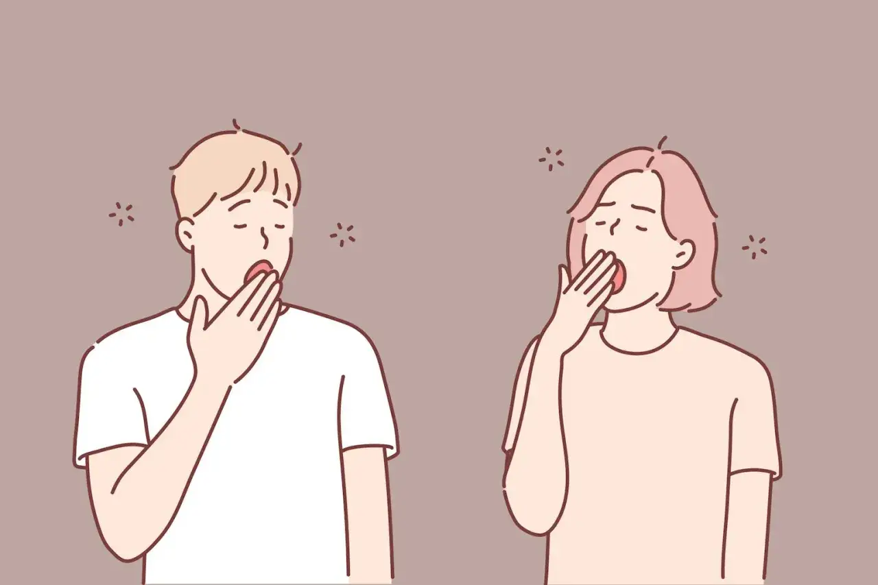 Para ludzi, co oznacza ziewanie podczas rozmowy? Ilustracja pokazuje parę ziewającą, co może sugerować nudę lub zmęczenie.